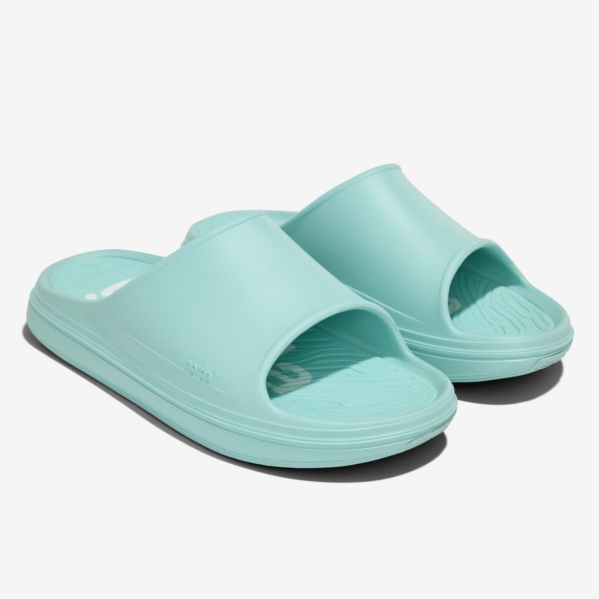 The norda 008 recovery slide supports your feet post-run with arch support, soft foam, and a grippy Vibram® ECOSTEP sole.
