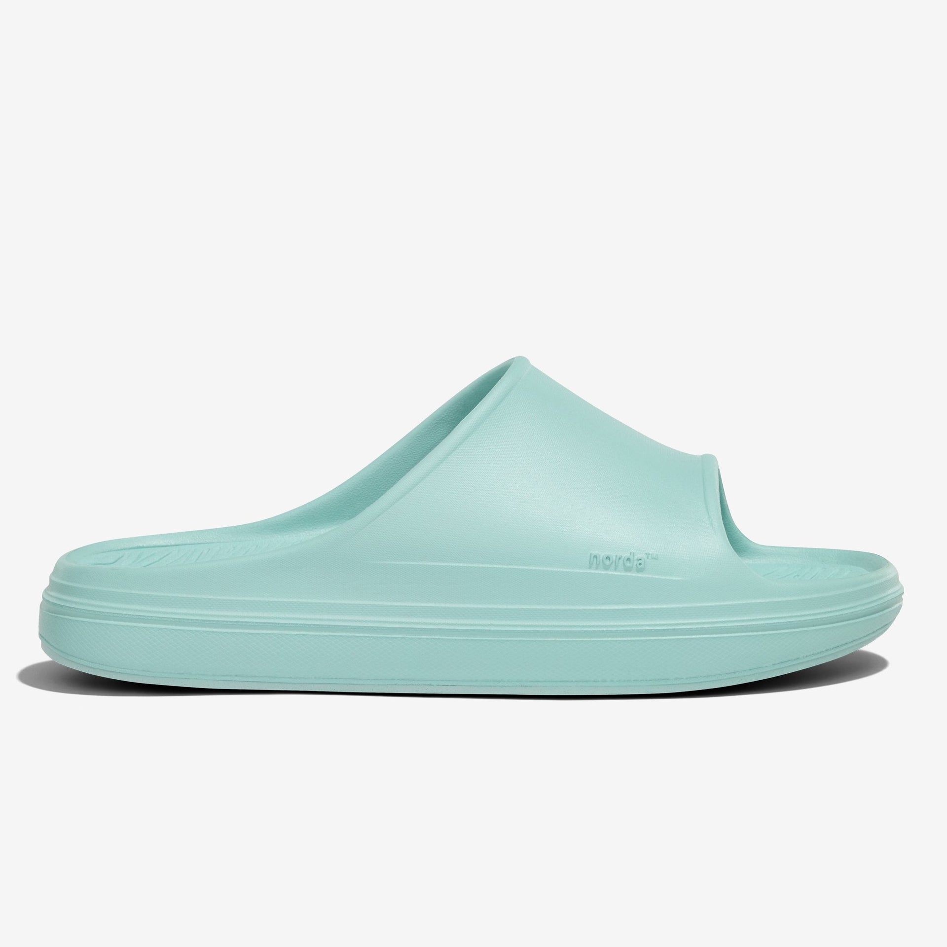 The norda 008 recovery slide supports your feet post-run with arch support, soft foam, and a grippy Vibram® ECOSTEP sole.