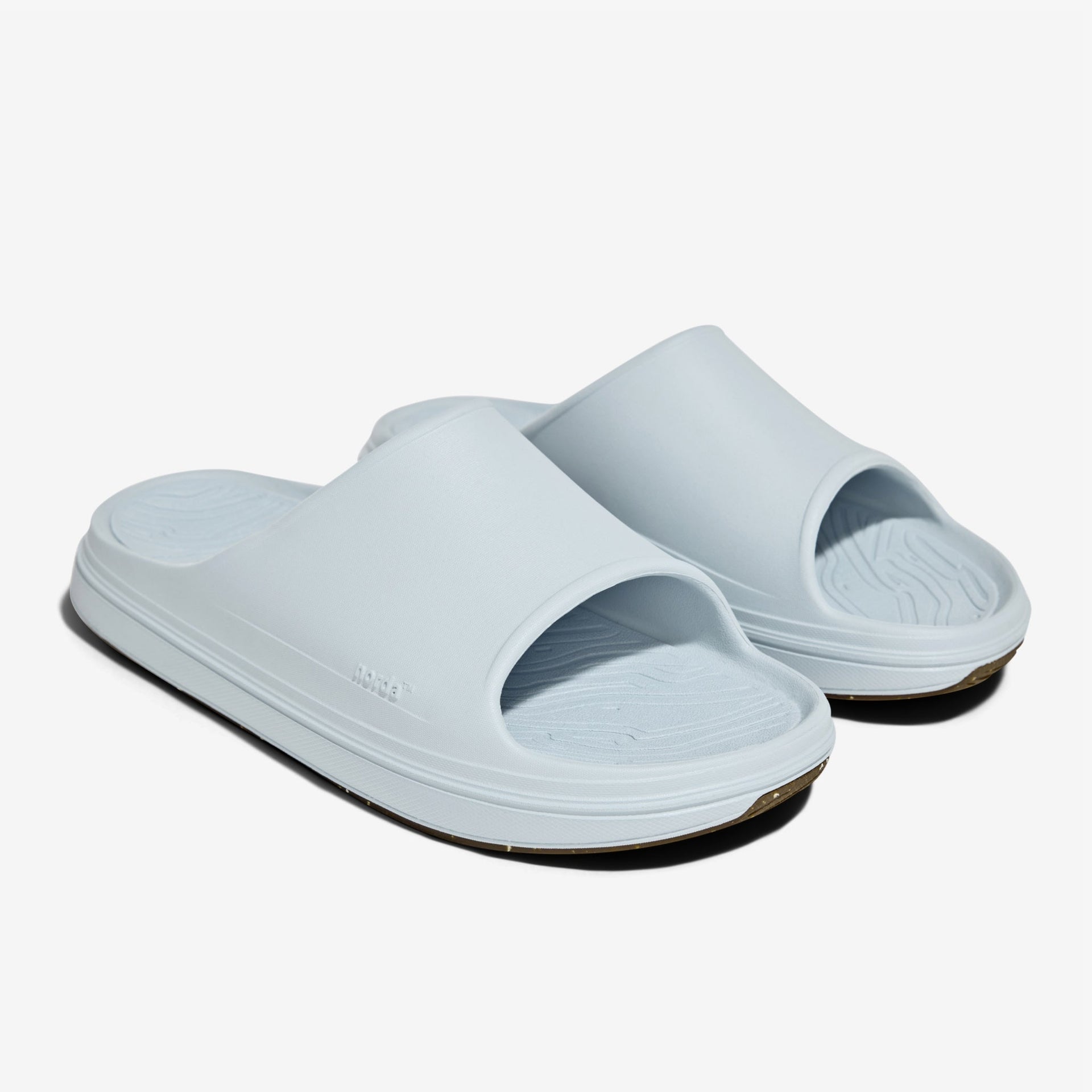 The norda® 008 recovery slide supports your feet post-run with arch support, soft foam, and a grippy Vibram® ECOSTEP sole.