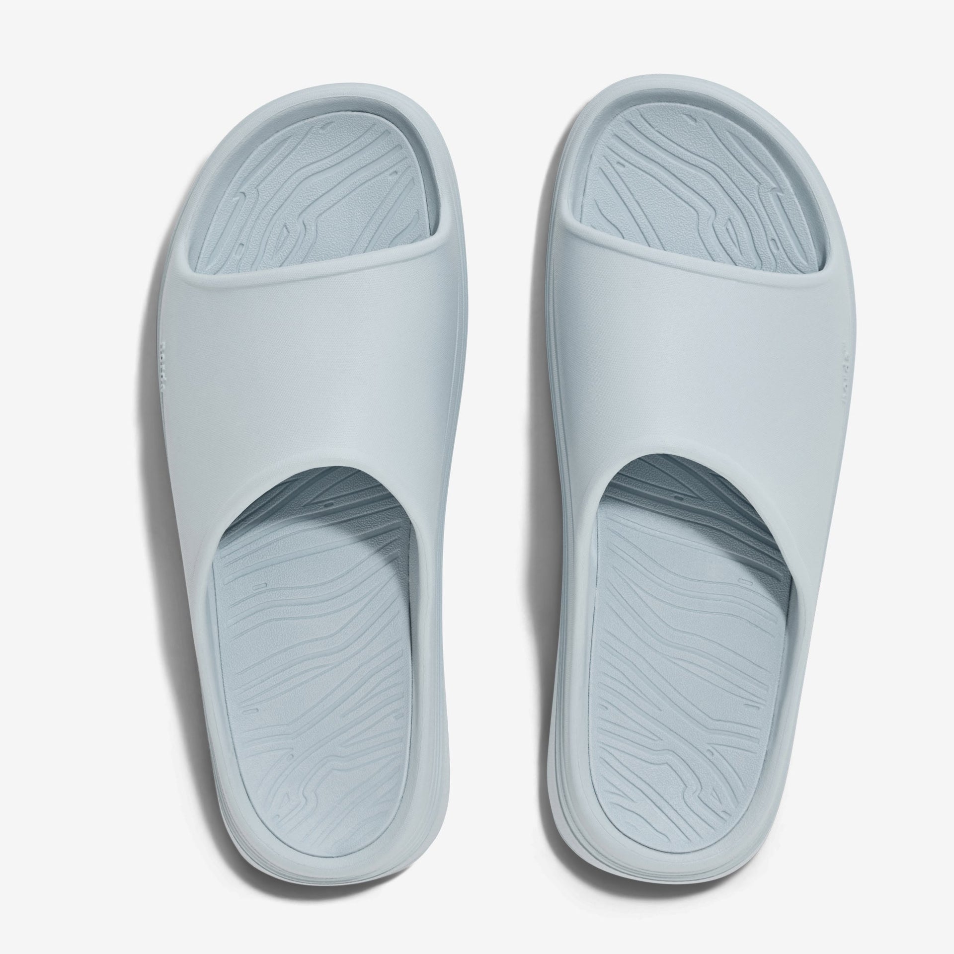 The norda® 008 recovery slide supports your feet post-run with arch support, soft foam, and a grippy Vibram® ECOSTEP sole.